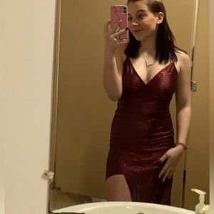 Shimmery maroon formal dress with sexy thigh slit.